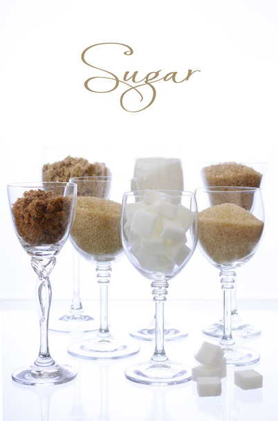 Different types of sugar in glasses on white.  - Photo, Image