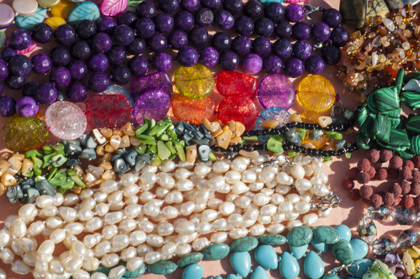 bead, chaplet, beading. a small piece of glass, stone, or similar material, typically rounded and perforated for threading with others as a necklace  - Photo, Image