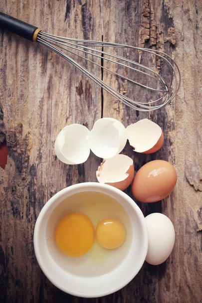 Eggs in a bowl with whisk - Zdjęcie, obraz