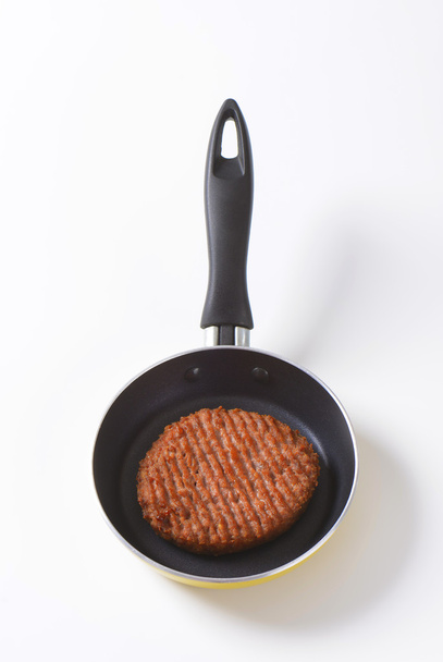 Beef burger patty in pan - Fotó, kép