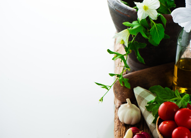 Fresh vegetables and olive oil on an old weathered wood with a o - Foto, imagen