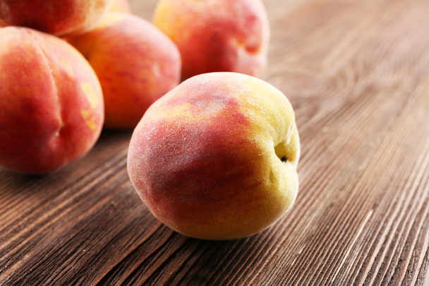 Fresh peaches on wooden table, closeup - Photo, Image