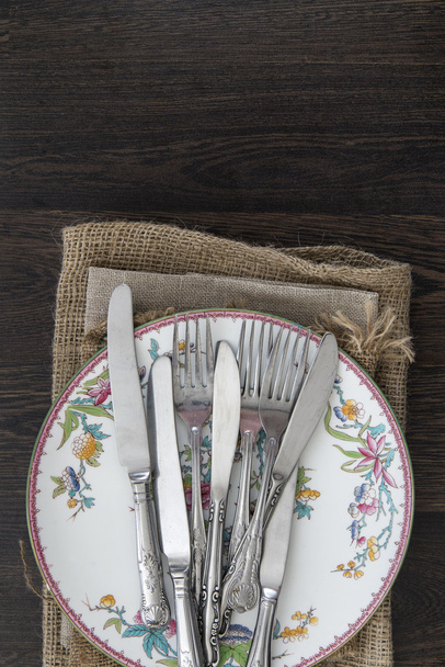 Vintage cutlery and crockery on cloths on rustic wooden backgrou - Photo, Image