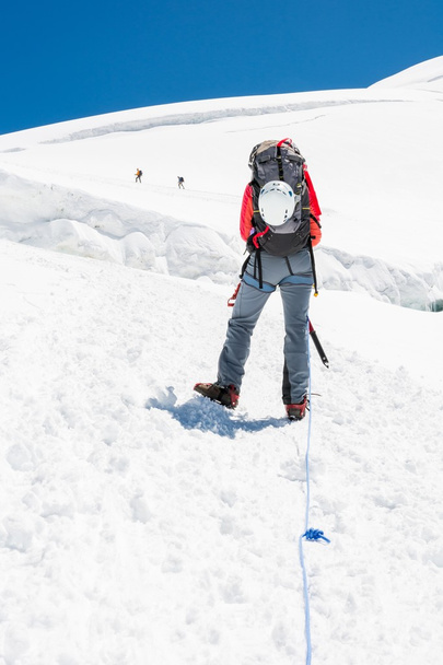 Female mountaineer ascending a glacier. - Photo, Image
