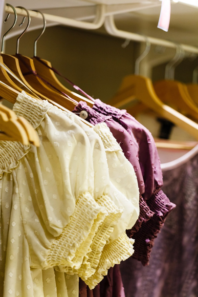bright clothing on hangers - Fotó, kép