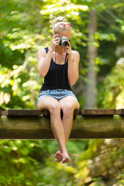 Woman in nature with retro camera. - Photo, Image