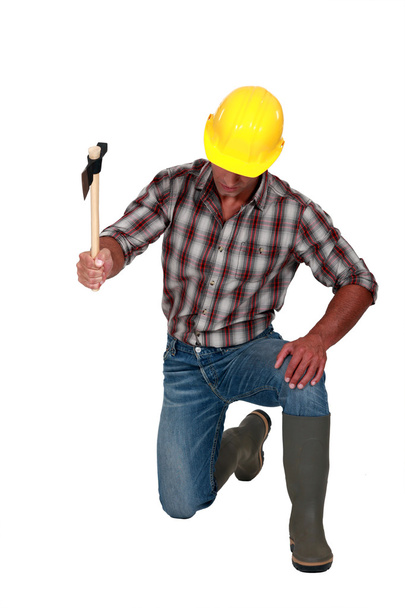 Trabajador de la construcción usando un hacha
 - Foto, Imagen