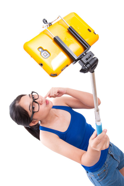 Happy woman taking picture with smartphone selfie stick - Photo, Image