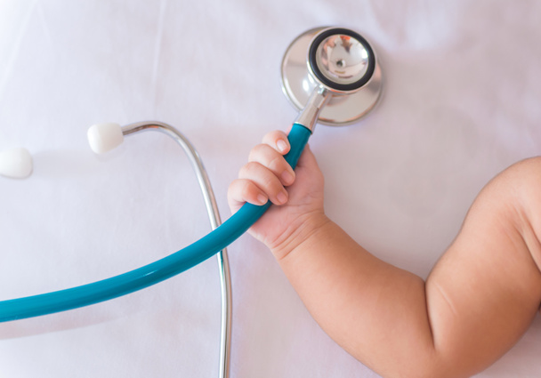 medical instruments stethoscope in hand of newborn baby girl - Photo, Image