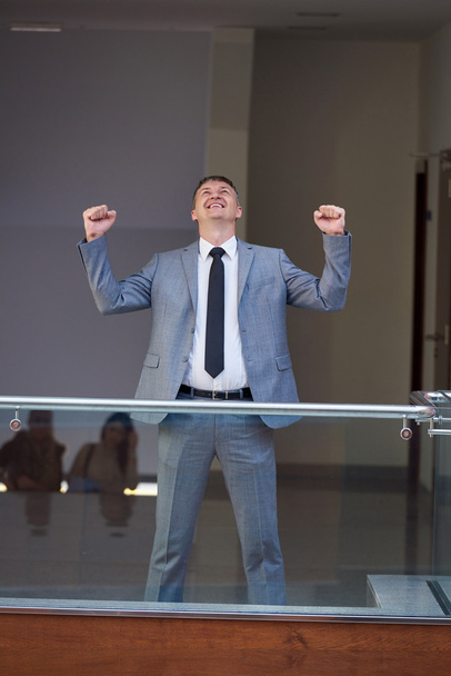 happy businessman raising hands from joy - Foto, Imagen