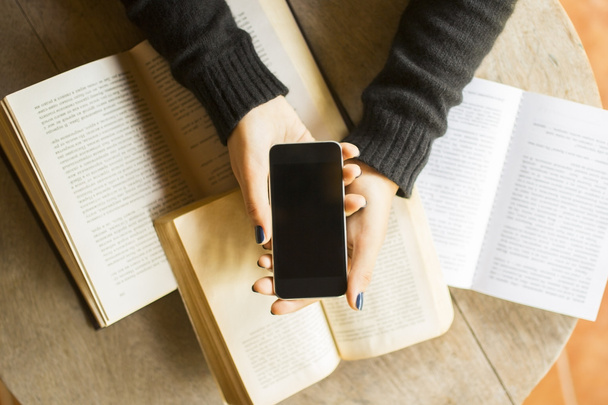 Girl with cell phone and books - Φωτογραφία, εικόνα