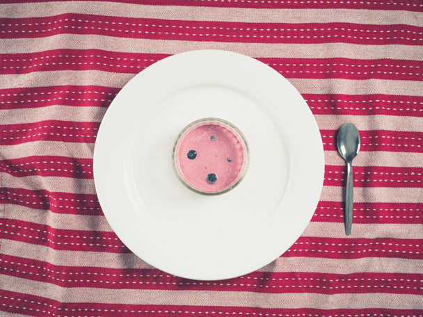 Yogurt and plate on tea towel - Foto, Imagen