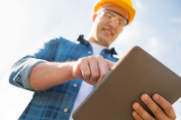 close up of builder in hardhat with tablet pc - Photo, Image