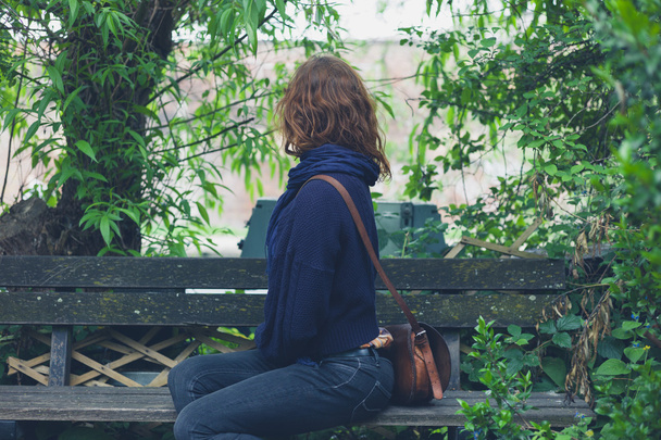 Woman sitting on bench in forest - Φωτογραφία, εικόνα
