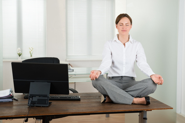 Businesswoman Doing Yoga In Office - Photo, Image