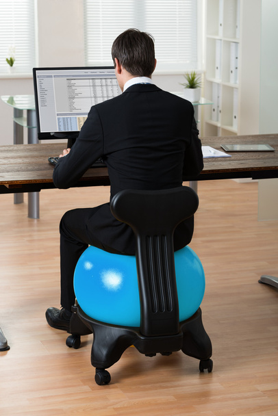 Businessman Sitting On Pilates Ball - Фото, зображення