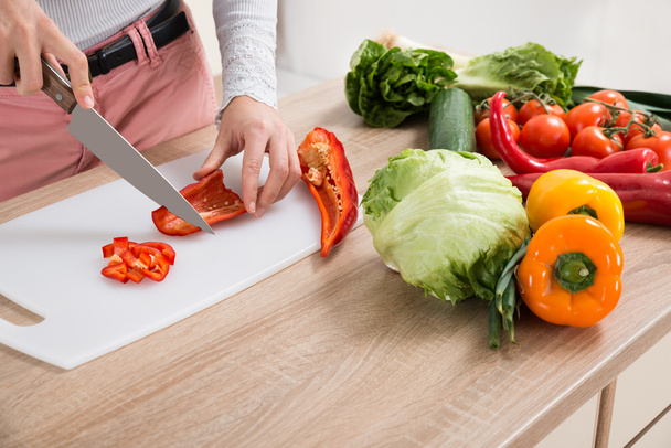Woman Chopping Chili Pepper With Knife - Zdjęcie, obraz