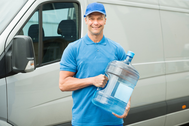 Delivery Man Holding Water Bottle - Фото, зображення