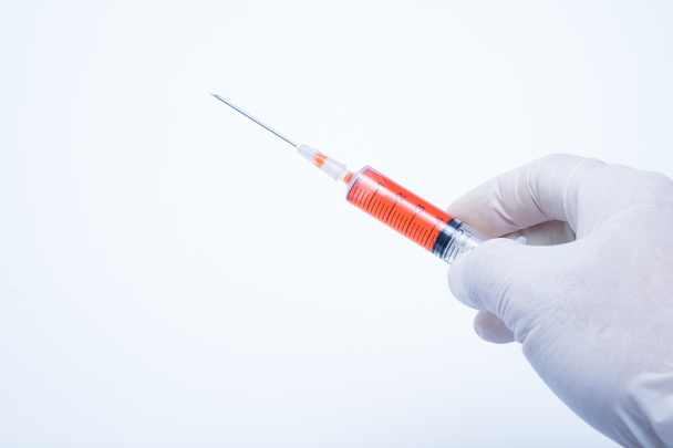 ręka trzyma strzykawka szczepionki czerwony - Zdjęcie, obraz