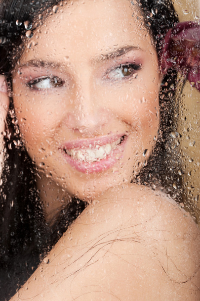 Big smile of a pretty woman behind glass - Фото, изображение