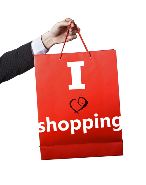 Hombre mano llevando y mostrando una bolsa roja aislada sobre fondo blanco Me encanta el lema de compras
 - Foto, Imagen