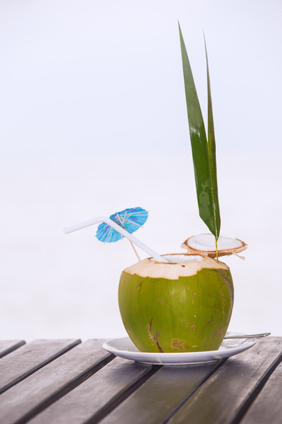 Coconut water drink served in coconut with drinking straw on the - Foto, Imagem