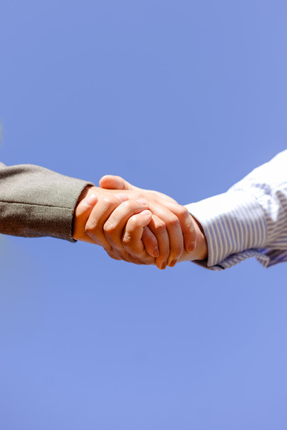 Close-up picture of business people handshaking on sunny day outdoors background - Photo, Image