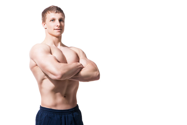 Muscular young man  shows the different movements and body parts - Foto, Imagen