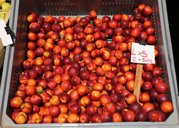 big Box of ripe Peach nectarines for sale at vegetable market - Photo, Image