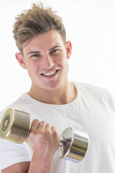 Smiling young man with gym weights - Zdjęcie, obraz