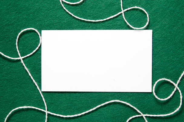 white blank business card on blurred background on green background - Φωτογραφία, εικόνα
