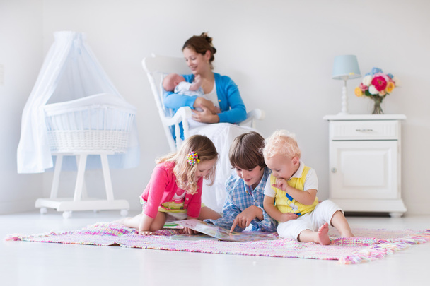 Mother and kids playing in bedroom - Photo, Image