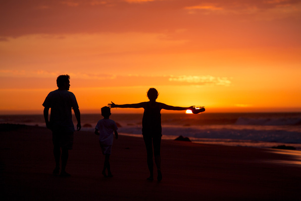 silhouette of family on the beach at dusk in Peru - 写真・画像