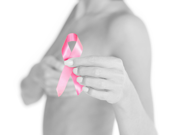 Рука тримає рожеву стрічку обізнаності про рак молочної залози
 - Фото, зображення