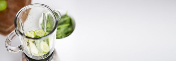 close up of blender jar and green vegetables - Zdjęcie, obraz