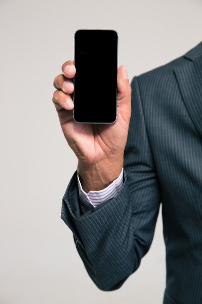 Businessman showing blank smartphone  - Fotó, kép