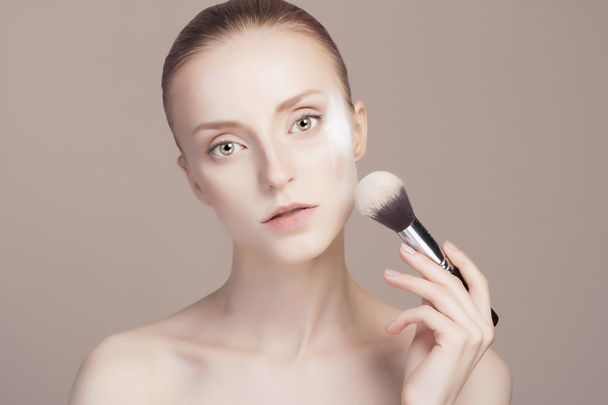 beautiful girl with make-up brush - Фото, изображение