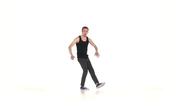 Young b-boy man doing brake dancing movements, on white, slow motion - Filmati, video