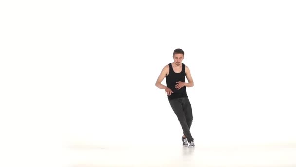 Young b-boy man in shirt doing brake dancing movements, on white, slow motion - Filmagem, Vídeo