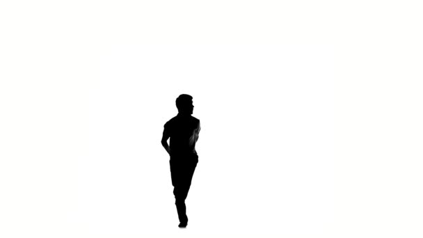 Young, man doing brake dancing movements, on white, slow motion, silhouette - Záběry, video