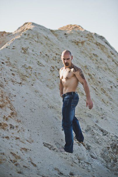 The man in jeans among sandy mountains 3391. - Fotó, kép