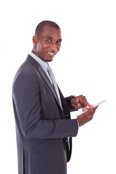 African american business man using a tactile tablet over white  - Фото, зображення