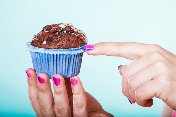 Sweet chocolate muffin human hands. Confectionery. - Photo, image
