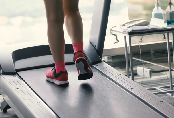 Woman running on treadmill - 写真・画像