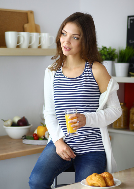 Portrait of a pretty woman holding glass with tasty juice - Zdjęcie, obraz