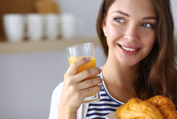Young woman with glass of juice and cakes - Φωτογραφία, εικόνα