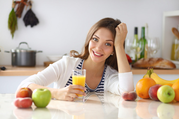 Portrait of a pretty woman holding glass with tasty juice - Foto, Imagen