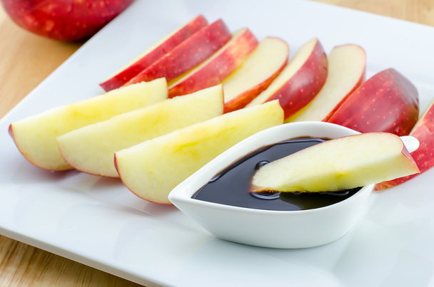 Apples with chocolate on wooden table - Foto, imagen