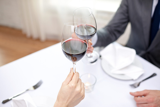 young couple with glasses of wine at restaurant - Foto, Bild