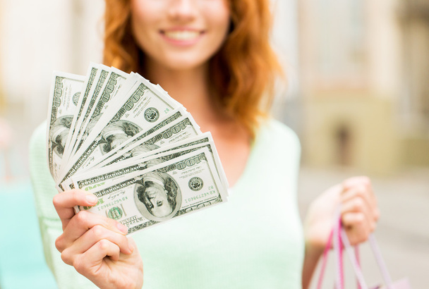 close up of woman with shopping bags and money - Photo, Image